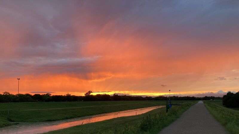 The West Fork at sunset, storm colour over the river and the trail running alongside it.